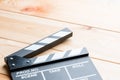 Close-up of an open video clapper on wooden boards view of a can