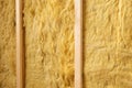 Close up of open wall with mineral wool isolation between wooden beams