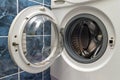 A close up of open washing machine in bathroom Royalty Free Stock Photo