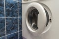 A close up of open washing machine in bathroom Royalty Free Stock Photo