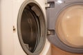 Close-up of opened washing machine in bathroom. Royalty Free Stock Photo