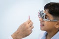 Close-up of Optometrist doing sight testing for child patient in clinic, Indian child choosing eyeglasses in optics store, Boy Royalty Free Stock Photo