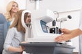 Ophthalmologist checking vision of little girl with autorefractor Royalty Free Stock Photo