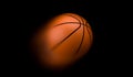 Close up orange basketball flying with motion blur