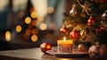 Close-up of an Orange Candle holder with some Christmas decorations put on a wood table just beside a Christmas tree