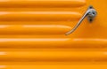 Close up of an orange car door with metallic handle Royalty Free Stock Photo
