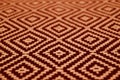 Close-up of orange and dark brown colored ethnic pattern fabric Royalty Free Stock Photo