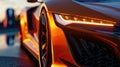 Close up of an orange futuristic sports car. Car headlights