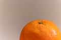 Close up of an orange in a grey background