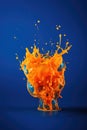 Close up of orange liquid splashing on blue background created using generative ai technology Royalty Free Stock Photo