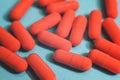 Close up many orange pills on the blue background Royalty Free Stock Photo