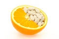 Close up of orange and pills isolated Royalty Free Stock Photo