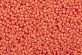 Close up of orange red seed beads. Royalty Free Stock Photo