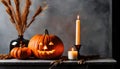 Close up of an orange scary carved pumpkin with candles