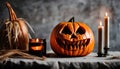 Close up of an orange scary carved pumpkin with candles