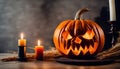 Close up of an orange scary carved pumpkin with candles