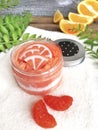 Close up orange sugar scrub with tangerine on towel. Royalty Free Stock Photo