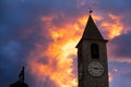 CLOSE UP: Orange summer sunset sky spans above an old Italian church tower. Royalty Free Stock Photo
