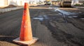 Close up of an orange traffic cone on the road Royalty Free Stock Photo