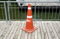 Close up an orange traffic cone on the wooden pier in the city park Royalty Free Stock Photo