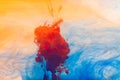 Close up of orange, yellow and blue ink in water with copy space background Royalty Free Stock Photo