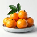 Close up of Oranges with Green Leaves on a White Plate and Background Royalty Free Stock Photo