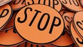 Close Up On Ordered Pile of Circular Orange Stop Signs