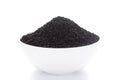 Close-up of Organic black cumin Nigella sativa or kalonjion a ceramic white bowl. Pile of Indian Aromatic Spice.