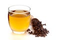 Close-Up of organic boiled water Tea or kada of clove syzygium aromaticum in a transparent glass cup over white background