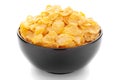 Close-Up of organic cereal corn flakes  in black ceramic bowl over white background Royalty Free Stock Photo