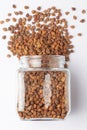 Close up of Organic chana or chickpea Cicer arietinum or whole white Bengal gram spilled and in a glass jar.