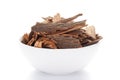 Close-up of Organic cinnamon Cinnamomum verum or dalchini on a ceramic white bowl. Pile of Indian Aromatic Spice.