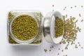 Close up of Organic green Gram Vigna radiata or whole green moong dal in a glass jar with Lid.