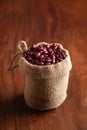 Close-up of Organic Rajma,  Laal Lobia  or red kidney beans dal in a standing jute bag over wooden brown background Royalty Free Stock Photo