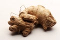 Close up on organic raw ginger tubers on white background.