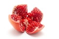 Close-up of organic red pomegranate in section cut of four pieces Punica granatum isolated over background