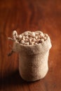 Close-up of Organic small chhole chana or Kabuli chana Cicer arietinum or whole white Bengal gram dal in a standing jute bag