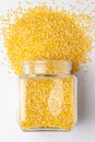 Close up of Organic yellow Gram Vigna radiata or split yellow moong dal, spilled and in a glass jar.