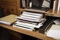 close-up of organized home office, with laptop, files, and notebook visible