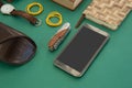 Organizer, wristwatch, pocketknife, mobile phone and sunglasses case on gr