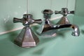 Close up of original green vintage retro 1930s deco wash basin and stainless steel taps. Royalty Free Stock Photo