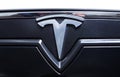 Close-up of original Tesla car logo on front side
