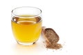 Close-Up of original organic boiled water Tea or kada with Ajwain Trachyspermum ammi in a transparent glass cup over white