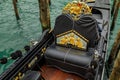 Close up of the ornamental detail of a traditional venetian gondola in a picturesque canal in Venice, Italy