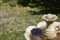 Rustic marble ornamental fountain with flowing and cascading water located in a garden