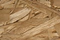 Close up OSB boards are made of brown wood chips sanded into a wooden background. Royalty Free Stock Photo