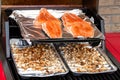 Close-up of an outdoor kitchen with an open flap showing fresh wild salmon steaks to be smoked Royalty Free Stock Photo