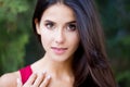 Close up outdoor portrait of young beautiful brunette woman with green eyes and long healthy hair. Royalty Free Stock Photo