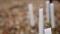 Close-up outdoor view of the candles and their outcoming smoke. Autumn forest location.