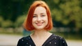 Close up outdoors portrait of human female face caucasian young girl redhead woman lady smiling outside nodding head yes Royalty Free Stock Photo